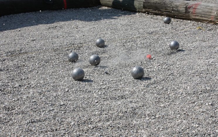 The Battle of Boules: Unraveling the Difference Between Petanque and Bocce